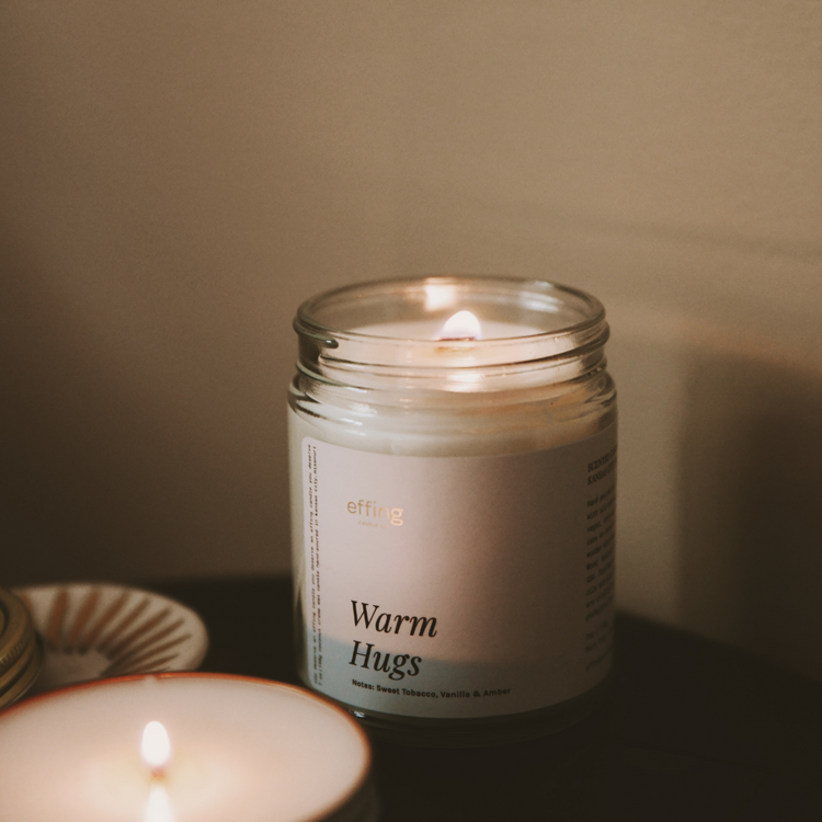 Warm Hugs Candle for your loved ones. Notes of sweet tobacco, vanilla and amber. 7oz glass jar with gold lid. Hand Poured in KCMO.