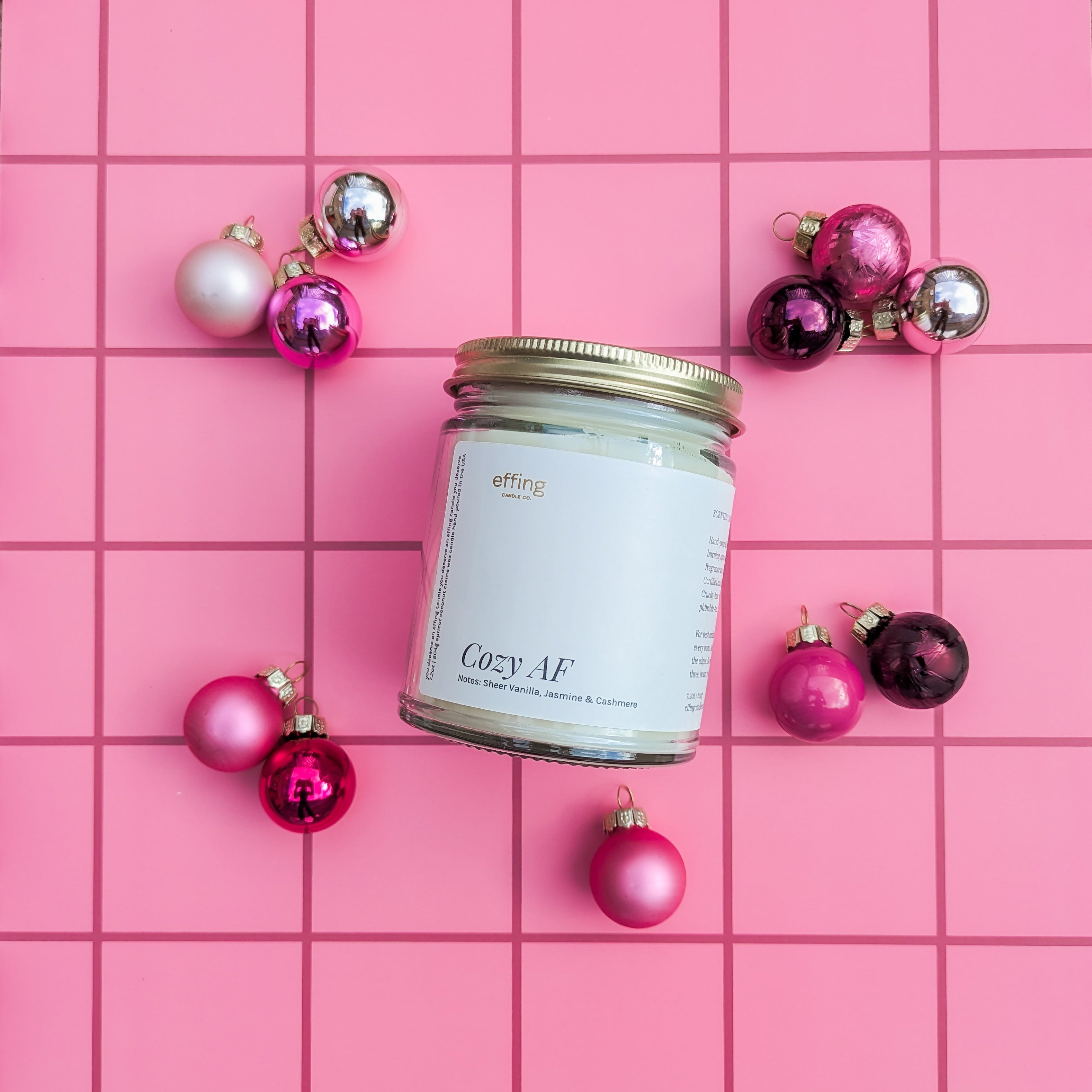 Cozy AF candle in a clear jar with a gold lid 