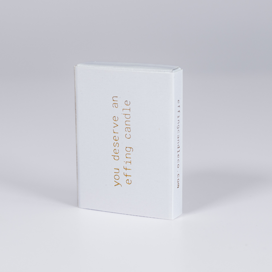 effing candle co branded matches in a white box that says "you deserve an effing candle" in gold lettering